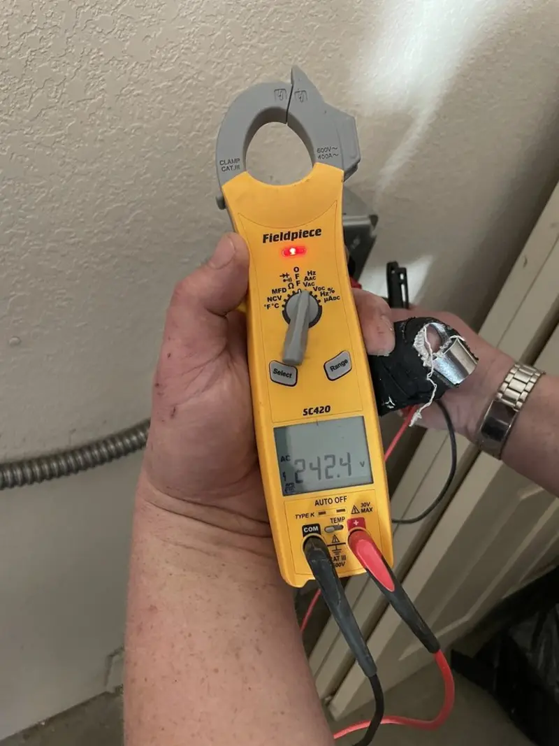 Voltage testing with clamp meter during Outlet Installation in Merton